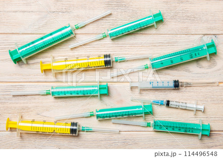 Top view of many syringes prepared for injection at wooden background. Treatment concept with copy space 114496548