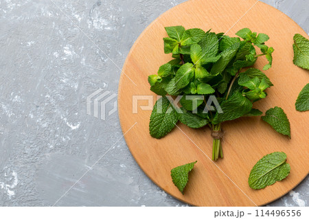Fresh mint on Cutting board table, top view. Flat lay Space for text 114496556
