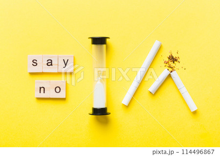 Cigarette And Wooden Blocks, Broken cigarette on table background with hourglass, No Tobacco Day with hourglass, clock health concept. time to quit smoking 114496867