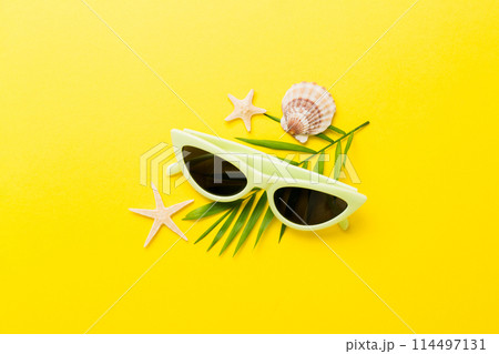 sunglasses with seashell lying on table background. Sunglasses on summer background. Top view flat lay with copy space for text sunglasses with seashell lying on table background. Sunglasses on summer background. Top view flat lay with copy space for text 114497131