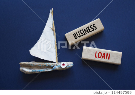 Business loan symbol. Concept words business loan on wooden blocks. Beautiful deep blue background with boat. Business and business loan concept. Copy space. Business loan symbol. Concept words business loan on wooden blocks. Beautiful deep blue background with boat. Business and business loan concept. Copy space. 114497599