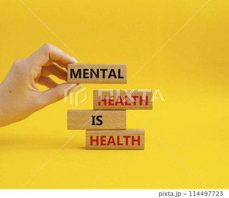 Mental Health symbol. Wooden blocks with words Mental Health is Health. Beautiful yellow background. Doctor hand. Medical and Health concept. Copy space. 114497723