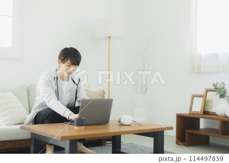 リビングでくつろぐ若い男性 リビングでくつろぐ若い男性 114497839