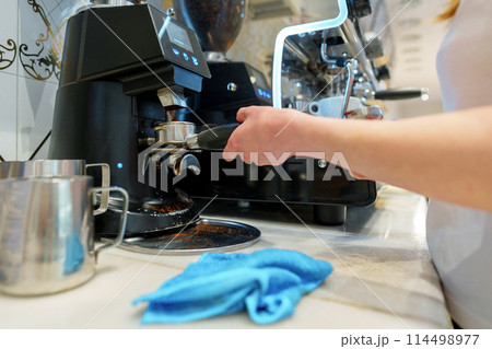 Barista Operating Espresso Machine at a Busy Coffee Shop During Morning Rush Barista Operating Espresso Machine at a Busy Coffee Shop During Morning Rush 114498977