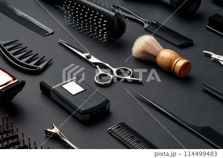 Variety of Hair Styling Tools and Accessories Displayed on a Dark Background 114499483