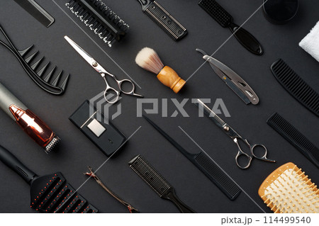 Variety of Hair Styling Tools and Accessories Displayed on a Dark Background 114499540