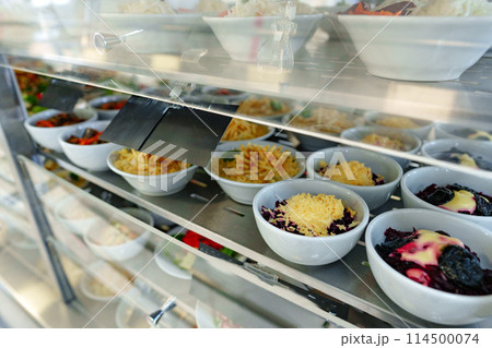 Bustling Cafeteria Serving Line During Lunchtime Offering a Variety of Dishes 114500074