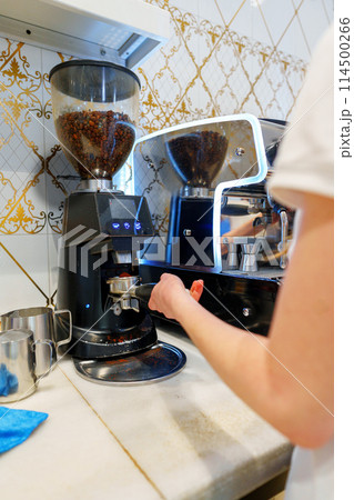 Barista Operating Espresso Machine at a Busy Coffee Shop During Morning Rush Barista Operating Espresso Machine at a Busy Coffee Shop During Morning Rush 114500266