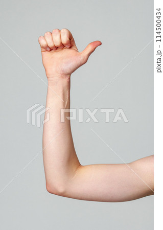 Young Adult Performing American Sign Language Letter L Against a Plain Background Young Adult Performing American Sign Language Letter L Against a Plain Background 114500434