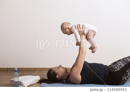 Home exercise for mother and baby, mommy and me workout. Using the baby's weight while lifting. 114500453