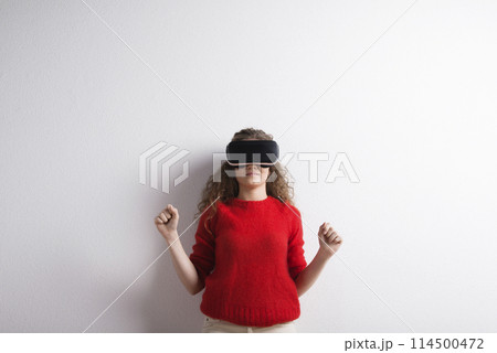 Young teenage girl with VR headset. Virutal reality, VR technology. Studio shot on white background with copy space. 114500472