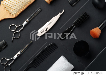 Variety of Hair Styling Tools and Accessories Displayed on a Dark Background Variety of Hair Styling Tools and Accessories Displayed on a Dark Background 114500505