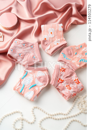Pastel composition with pink socks on white background 114501279