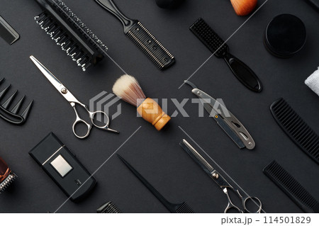 Variety of Hair Styling Tools and Accessories Displayed on a Dark Background 114501829