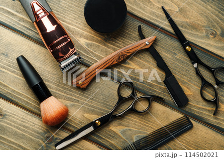 Hairdressing barber tools on wooden background close up Hairdressing barber tools on wooden background close up 114502021