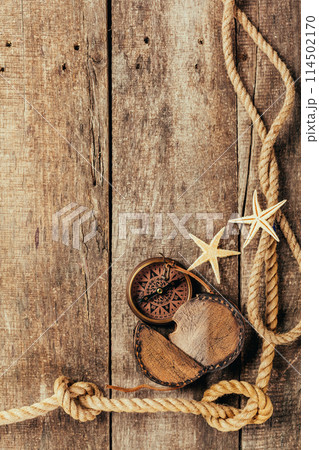 ship ropes and compass on wooden background 114502170