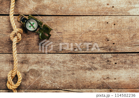 ship ropes and compass on wooden background ship ropes and compass on wooden background 114502236