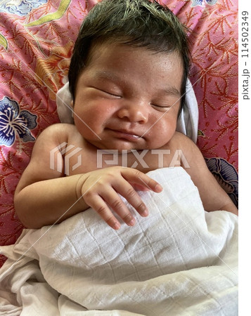 Portrait of cute Asian newborn baby girl sleeping peacefully with a white blanket on the bed in the morning at home Portrait of cute Asian newborn baby girl sleeping peacefully with a white blanket on the bed in the morning at home 114502349