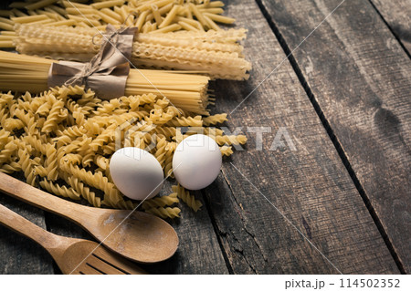 Pasta spaghetti with flour, egg on old wooden background 114502352