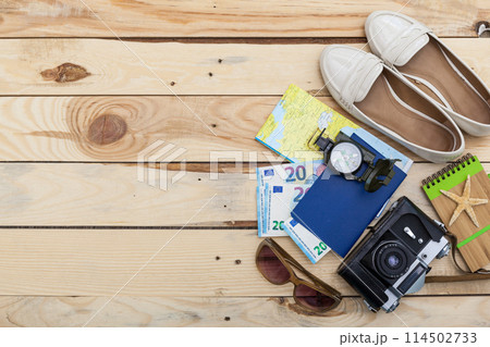 Accessories for travel. Passport, photo camera and travel map. Top view. Holidays and tourism concept 114502733
