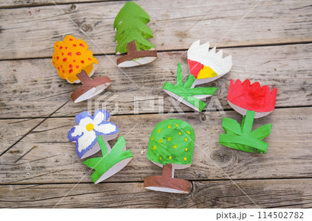 Kids craft trees and flowers out of recycling toilet paper roll, zero waste concept. 114502782