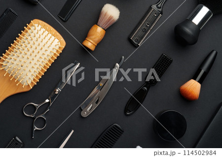Variety of Hair Styling Tools and Accessories Displayed on a Dark Background 114502984