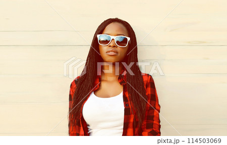 Portrait of stylish young african woman posing in casual clothes, sunglasses on white background 114503069