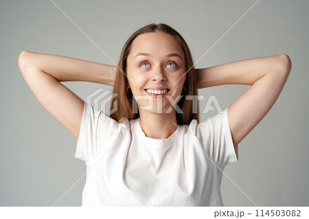 Thinking young lady standing over gray background Thinking young lady standing over gray background 114503082