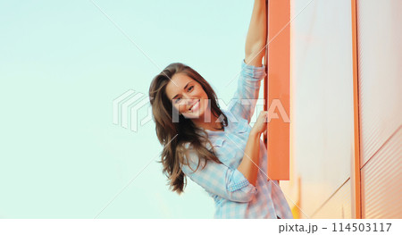 Portrait beautiful happy smiling brunette young woman posing in the city 114503117