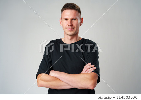 Portrait of a young handsome male in casual clothes on gray background 114503330
