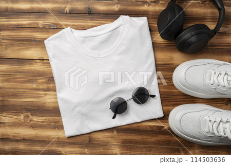 Cotton T-shirt mock up on wooden background flat lay Cotton T-shirt mock up on wooden background flat lay 114503636
