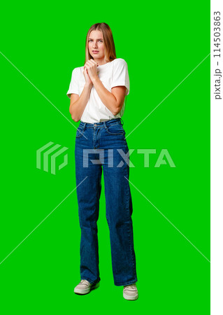 Young Woman With Pursed Lips Expressing Skepticism Against Green Screen Background Young Woman With Pursed Lips Expressing Skepticism Against Green Screen Background 114503863
