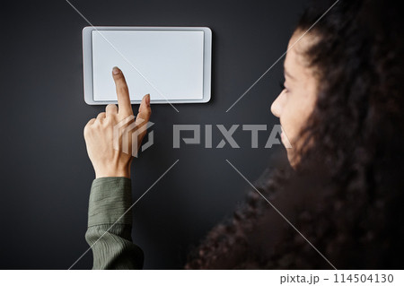 Closeup of young biracial woman adjusting indoor temperature with use of smart home system Closeup of young biracial woman adjusting indoor temperature with use of smart home system 114504130