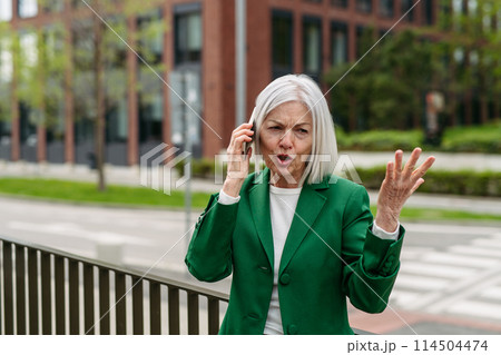 Mature businesswoman is angry, phone calling smartphone with business partner. Phone conflict, difficult customer. 114504474