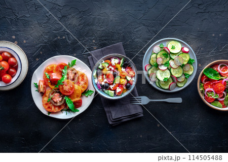 Fresh salads, overhead flat lay shot of an assortment. Variety of plates Fresh salads, overhead flat lay shot of an assortment. Variety of plates 114505488