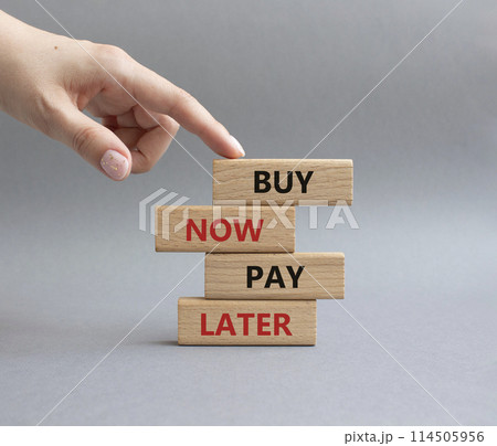 Buy now Pay later symbol. Concept word Buy now Pay later on wooden block. Businessman hand. Beautiful grey background. Business and Buy now Pay later concept. Copy space 114505956
