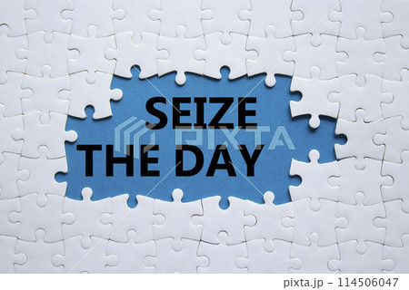 Seize the day symbol. White puzzle with words Seize the day. Beautiful blue background. Business and Seize the day concept. Copy space. Seize the day symbol. White puzzle with words Seize the day. Beautiful blue background. Business and Seize the day concept. Copy space. 114506047