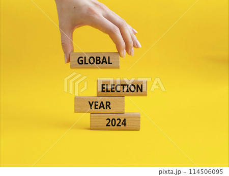 Global Election year 2024 symbol. Concept words Global Election year 2024 on wooden blocks. Beautiful yellow background. Businessman hand. Business and Global Election year 2024 concept. Copy space Global Election year 2024 symbol. Concept words Global Election year 2024 on wooden blocks. Beautiful yellow background. Businessman hand. Business and Global Election year 2024 concept. Copy space 114506095