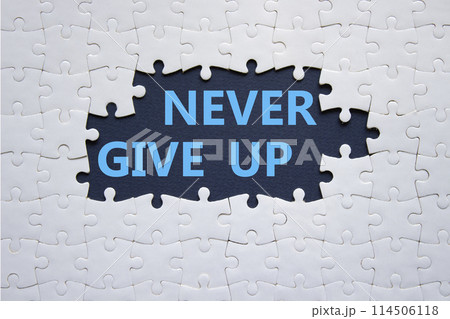 Never give up symbol. Concept words Never give up on white puzzle. Beautiful deep blue background. Business and Never give up concept. Copy space. Never give up symbol. Concept words Never give up on white puzzle. Beautiful deep blue background. Business and Never give up concept. Copy space. 114506118
