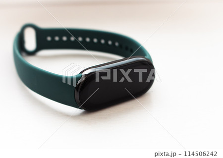 Fitness tracker with mockup screen and green strap on white background. Sport wristband with template. Portable smartwatch. Healthy lifestyle equipment. Sportwear device isolated. Fitness tracker with mockup screen and green strap on white background. Sport wristband with template. Portable smartwatch. Healthy lifestyle equipment. Sportwear device isolated. 114506242