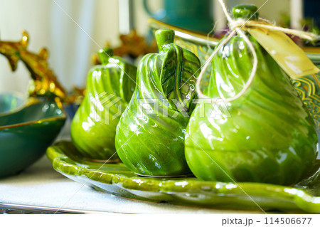 Green Ceramic Pear-Shaped Containers on a Plate With Rustic Kitchen Decor 114506677