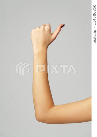Female hand OK sign on gray background Female hand OK sign on gray background 114506850
