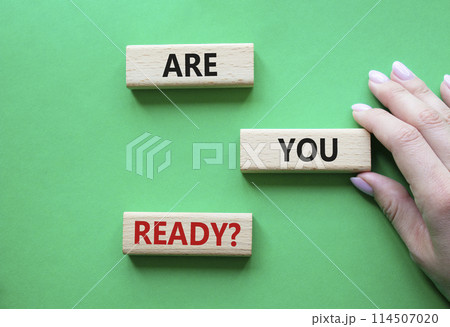 Are you ready symbol. Concept word Are you ready on wooden blocks. Businessman hand. Beautiful green background. Business and Are you ready concept. Copy space 114507020