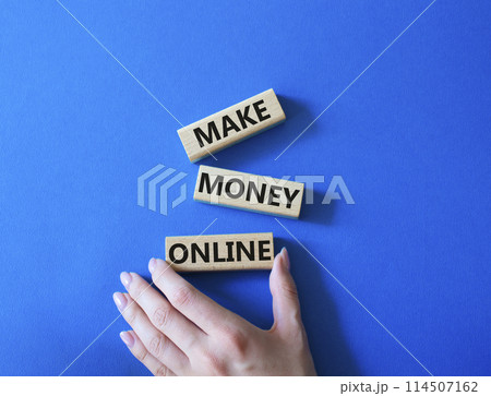 Make Money Online symbol. Concept words Make Money Online on wooden blocks. Businessman hand. Beautiful blue background. Business and Make Money Online concept. Copy space. Make Money Online symbol. Concept words Make Money Online on wooden blocks. Businessman hand. Beautiful blue background. Business and Make Money Online concept. Copy space. 114507162