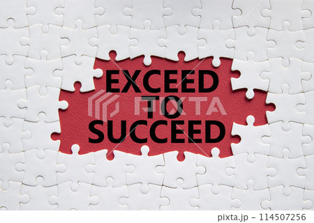 Exceed to succeed symbol. Concept words Exceed to succeed on white puzzle. Beautiful red background. Business and Exceed to succeed concept. Copy space. 114507256