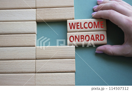 Welcome onboard symbol. Concept words Welcome onboard on wooden blocks. Beautiful grey green background. Businessman hand. Business and Welcome onboard concept. Copy space. Welcome onboard symbol. Concept words Welcome onboard on wooden blocks. Beautiful grey green background. Businessman hand. Business and Welcome onboard concept. Copy space. 114507312