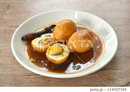 fried egg half cut dressing sweet tamarind sauce topping chili on plate fried egg half cut dressing sweet tamarind sauce topping chili on plate 114507395
