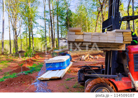 Contractor using forklift working on delivery construction of building materials in construction site Contractor using forklift working on delivery construction of building materials in construction site 114509107