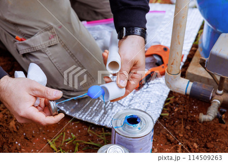 Glue is applied to pvc pipe before it is glued Glue is applied to pvc pipe before it is glued 114509263