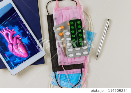 Cardiology doctor examines 3D radiology scan of rendering for patient heart during an examination in hospital on digital tablet Cardiology doctor examines 3D radiology scan of rendering for patient heart during an examination in hospital on digital tablet 114509284